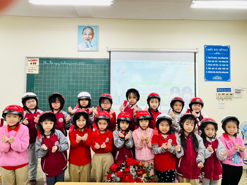 A group of children in red and white uniforms in front of a chalkboard

Description automatically generated with low confidence