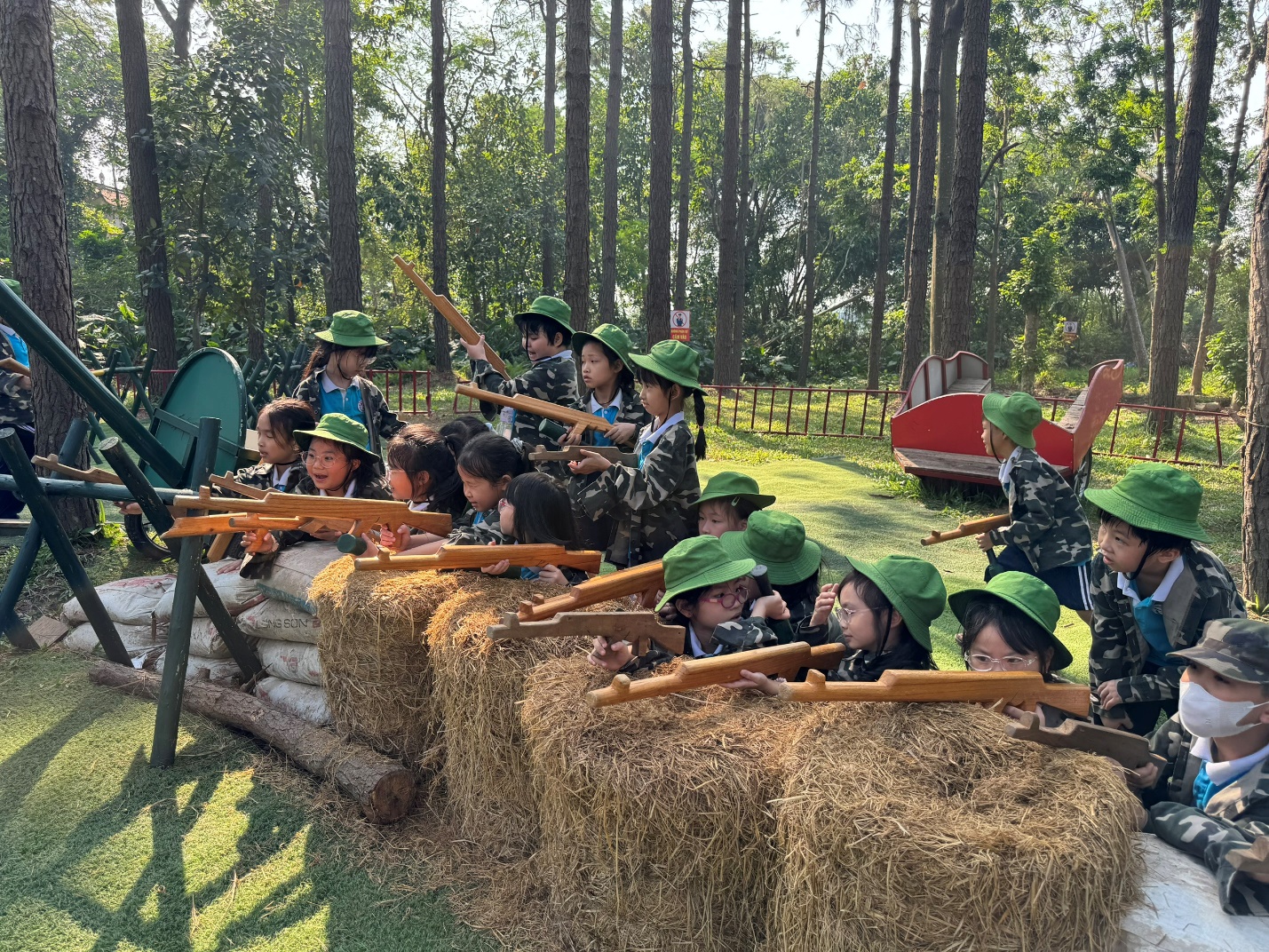 A group of children in clothing shooting from an object

Description automatically generated