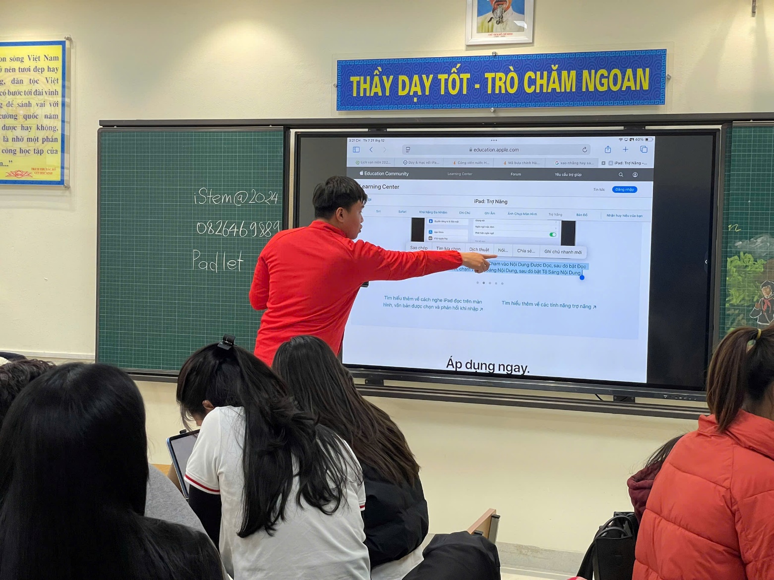 A person pointing at a screen
Description automatically generated