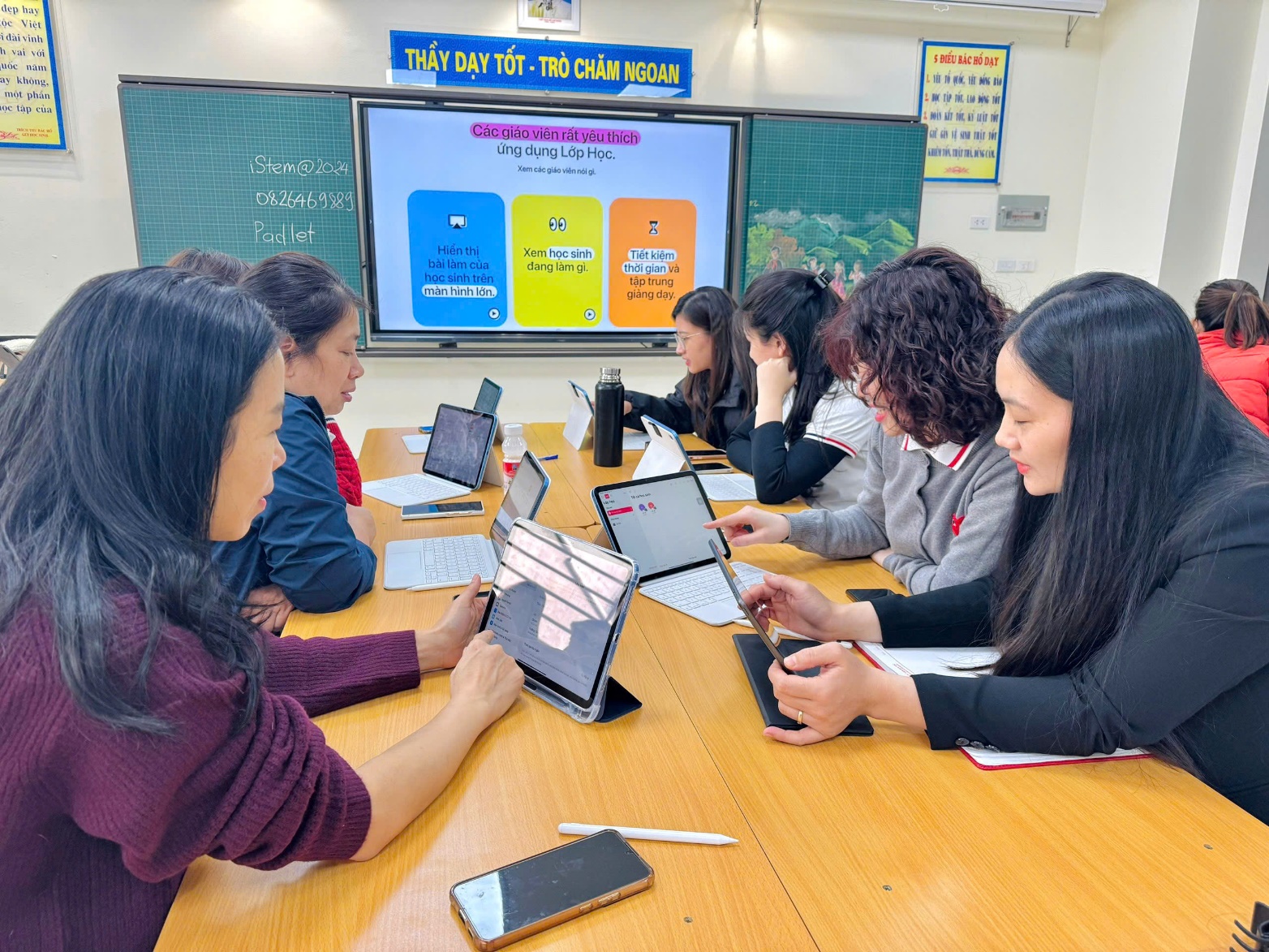 A group of women sitting at a table with laptops
Description automatically generated