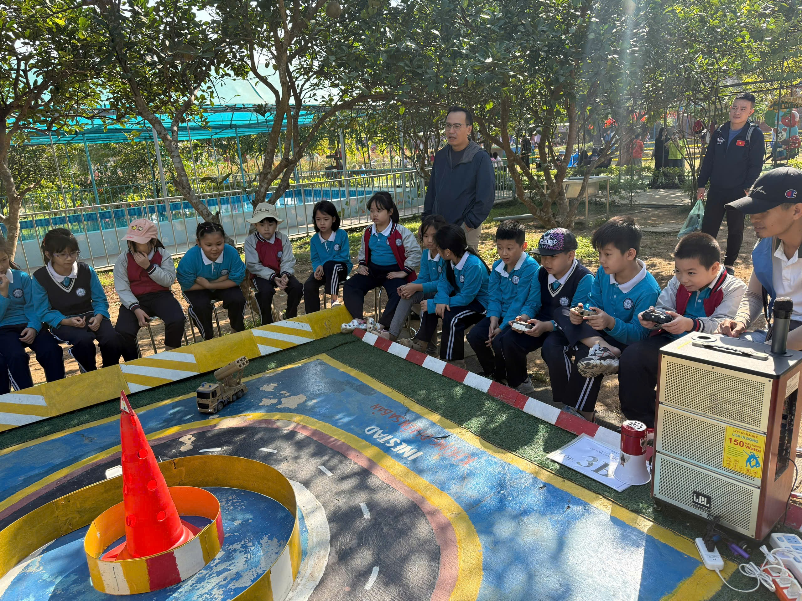 A group of children sitting on a small board
AI-generated content may be incorrect.