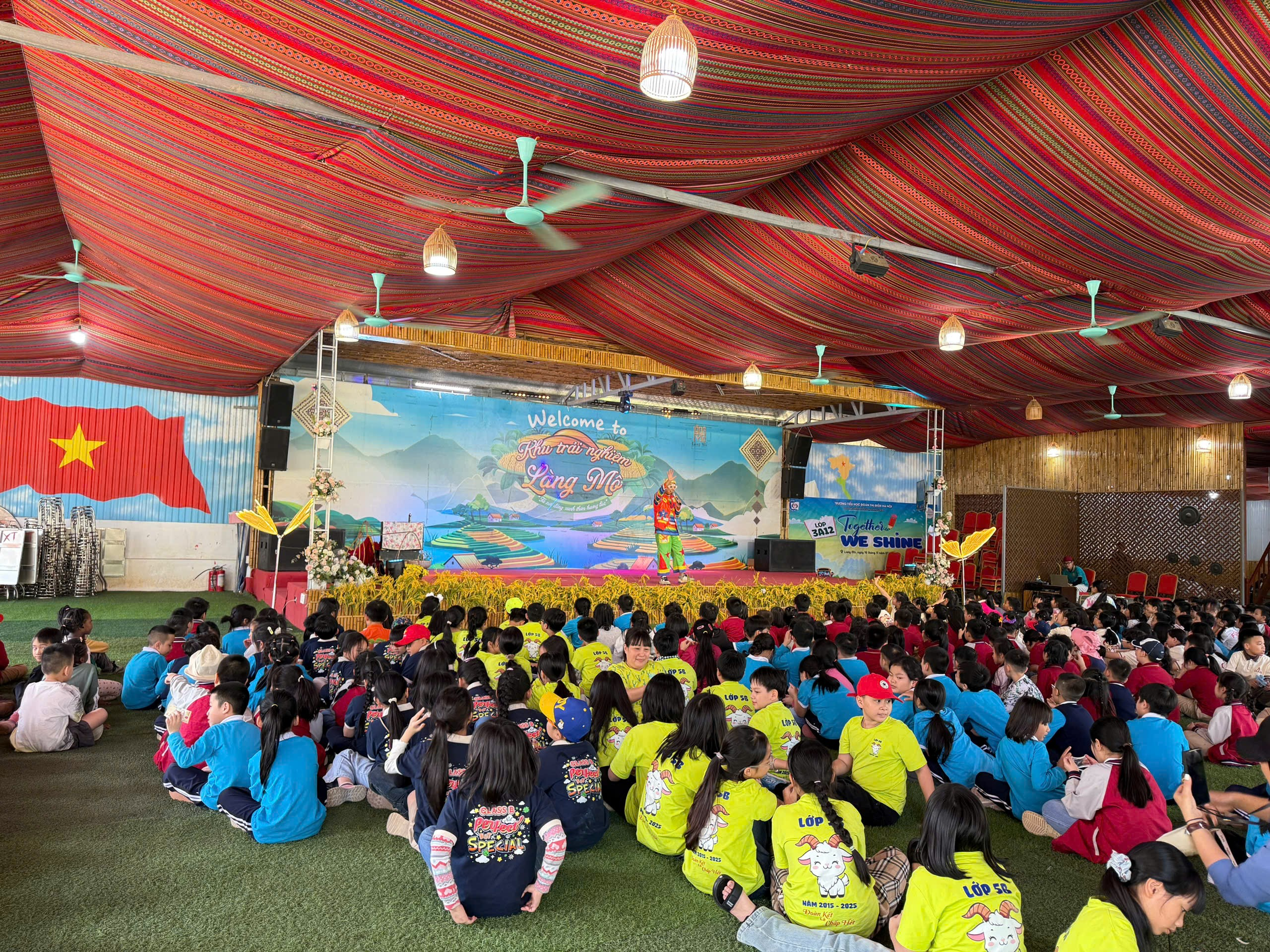 A group of people sitting on the ground in a tent
AI-generated content may be incorrect.