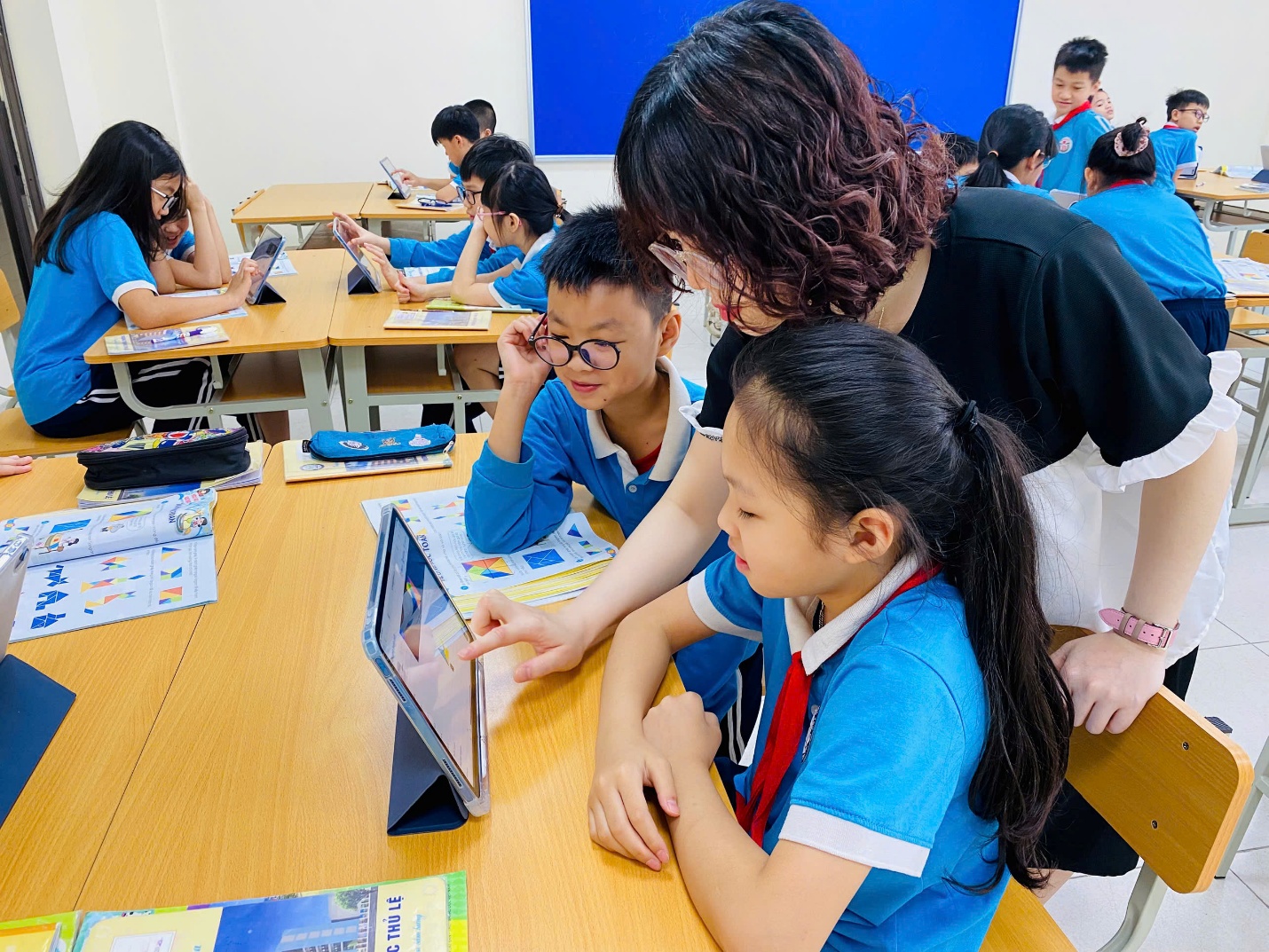 A group of kids sitting at a table with a person looking at a tablet

AI-generated content may be incorrect.