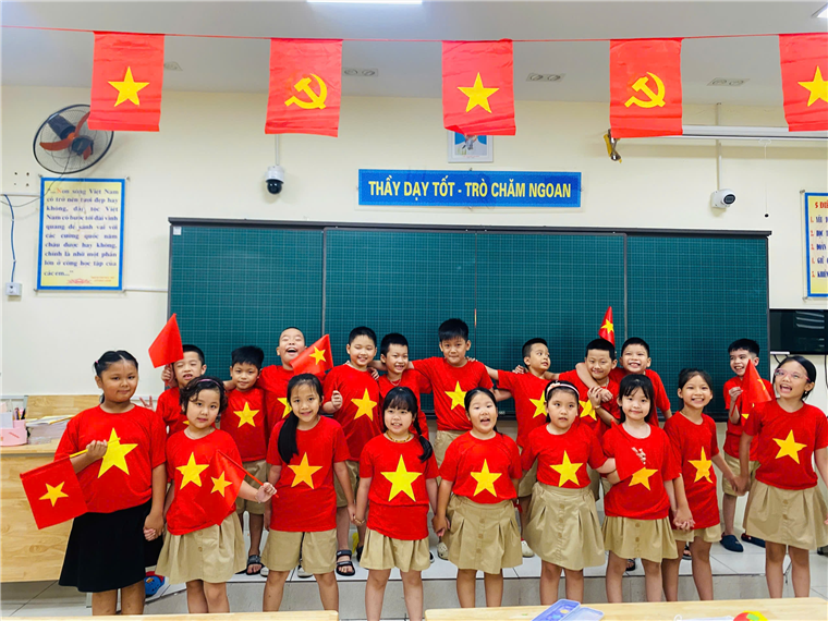 A group of children wearing red shirts and standing in a classroom
AI-generated content may be incorrect.