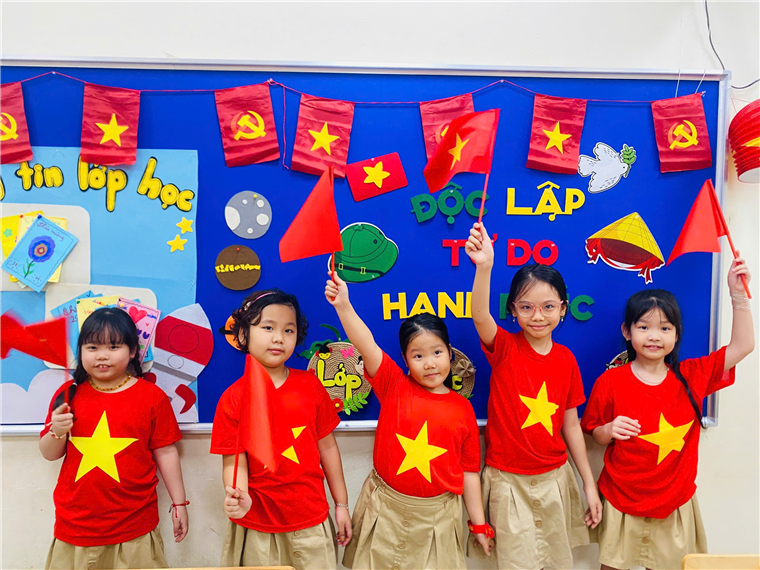 A group of girls in red shirts and tan pants holding flags
AI-generated content may be incorrect.