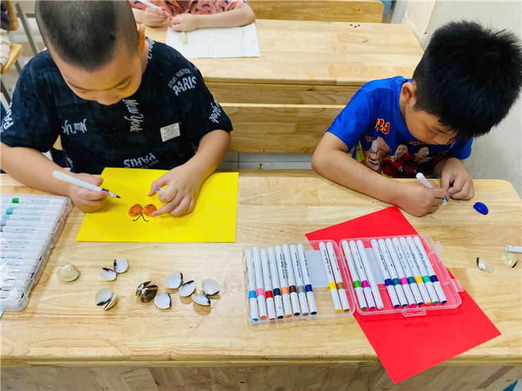 Two boys sitting at a table coloring
AI-generated content may be incorrect.
