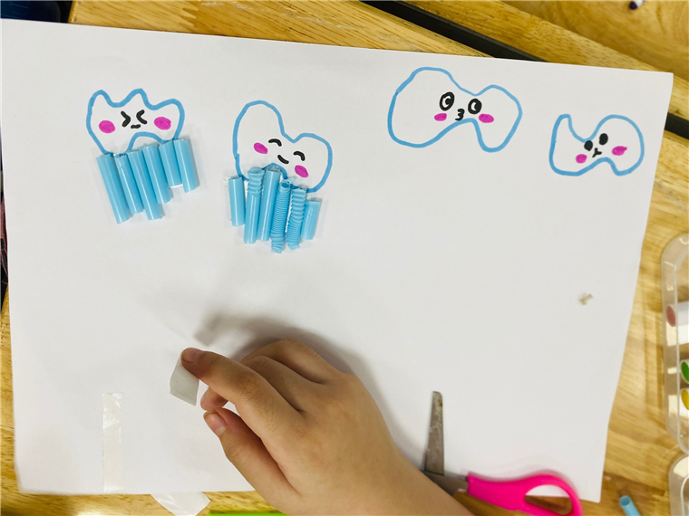 A child's hand holding a piece of paper with a toothpick
AI-generated content may be incorrect.